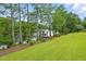 Picturesque view of a private dock with watercraft on a tranquil lake surrounded by lush trees at 1093 N Lakeside Dr, Smithfield, NC 27577