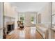 Living room with a fireplace and hardwood floors with an abundance of natural light at 1093 N Lakeside Dr, Smithfield, NC 27577