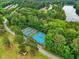 An aerial view of the well-kept community tennis courts surrounded by lush trees near a community at 1093 N Lakeside Dr, Smithfield, NC 27577