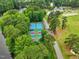 Aerial view of well-maintained community tennis courts surrounded by lush greenery, perfect for active residents at 1093 N Lakeside Dr, Smithfield, NC 27577