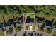 Aerial view of a home surrounded by mature trees and well-maintained lawns in a suburban neighborhood at 1148 Dexter Ridge Dr, Holly Springs, NC 27540