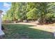 Large backyard with a wooden fence and mature trees create a private outdoor space at 1148 Dexter Ridge Dr, Holly Springs, NC 27540