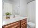 A vanity with a brown cabinet and a white sink in a bathroom at 1148 Dexter Ridge Dr, Holly Springs, NC 27540