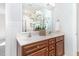 Bathroom with a double vanity featuring dark wood cabinets, a large mirror, and decorative flowers at 1148 Dexter Ridge Dr, Holly Springs, NC 27540