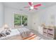 Charming bedroom with a plush rug, window, and whimsical decor at 1148 Dexter Ridge Dr, Holly Springs, NC 27540