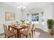 Bright dining room featuring natural light from windows, a chandelier and wood dining table at 1148 Dexter Ridge Dr, Holly Springs, NC 27540