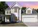 Inviting two-story home with a two-car garage, bay window and manicured lawn and yellow siding at 1148 Dexter Ridge Dr, Holly Springs, NC 27540