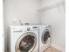 Well-lit laundry area featuring a side-by-side washer and dryer at 1148 Dexter Ridge Dr, Holly Springs, NC 27540