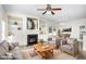 Bright and airy living room with a fireplace, built-in shelving, neutral colors, and plush seating at 1148 Dexter Ridge Dr, Holly Springs, NC 27540