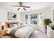 Bright main bedroom with a ceiling fan, bay window, and neutral color palette and wood furniture at 1148 Dexter Ridge Dr, Holly Springs, NC 27540