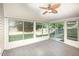 Bright sunroom with a ceiling fan, large windows, and neutral carpet at 1148 Dexter Ridge Dr, Holly Springs, NC 27540