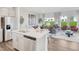 Open-concept living room and kitchen area with modern decor, stainless appliances, and plenty of natural light at 1167 Abbott St, Mebane, NC 27302