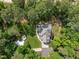 Aerial view showcasing a landscaped yard, patio and fire pit, and lush greenery surrounding the property at 120 Harmony Hill Ln, Cary, NC 27513