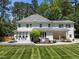 Beautiful backyard with a stone patio, manicured lawn, and a charming porch swing at 120 Harmony Hill Ln, Cary, NC 27513