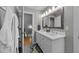 Bright bathroom features a double sink vanity with a white countertop and grey tile flooring at 120 Harmony Hill Ln, Cary, NC 27513