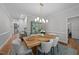 Chic dining room with seating for six, a modern chandelier, and a decorative china cabinet at 120 Harmony Hill Ln, Cary, NC 27513