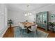 Elegant dining room featuring a wooden table with seating for six and a stylish china cabinet at 120 Harmony Hill Ln, Cary, NC 27513