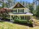 Beautiful home with a covered porch, white columns, lush landscaping, and an attached screen porch on a wooded lot at 120 Harmony Hill Ln, Cary, NC 27513