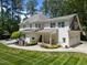 Stunning white home exterior featuring an inviting covered porch with a swing and a two-car garage at 120 Harmony Hill Ln, Cary, NC 27513