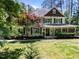 Charming two-story traditional-style home featuring a cozy front porch and well-manicured lawn and mature trees at 120 Harmony Hill Ln, Cary, NC 27513