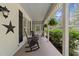 Relaxing front porch with rocking chairs, fern hangings and a beadboard ceiling at 120 Harmony Hill Ln, Cary, NC 27513