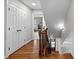 Bright hallway with hardwood floors, closet space and entryway to the stairs at 120 Harmony Hill Ln, Cary, NC 27513
