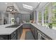 Bright kitchen with gray cabinets, quartz countertops, stainless appliances, and a large window at 120 Harmony Hill Ln, Cary, NC 27513