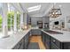 Bright kitchen with gray cabinets, quartz countertops, stainless appliances, and a large window at 120 Harmony Hill Ln, Cary, NC 27513