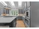 Stylish kitchen showcases quartz countertops, gray cabinets, stainless appliances, island with gas cooktop, and a large window at 120 Harmony Hill Ln, Cary, NC 27513