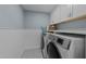 Functional laundry room with modern appliances, cabinetry, and a patterned tile floor at 120 Harmony Hill Ln, Cary, NC 27513