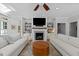 Bright living room with a fireplace, built-in shelves, a ceiling fan and modern furnishings at 120 Harmony Hill Ln, Cary, NC 27513