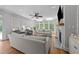 Bright living room with large windows, a fireplace, built-in shelves, hardwood floors and modern furnishings at 120 Harmony Hill Ln, Cary, NC 27513