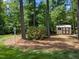 Backyard shed featuring surrounding trees and pine straw at 120 Harmony Hill Ln, Cary, NC 27513