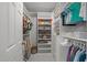 Organized walk-in closet with custom shelving, hanging rods, and built-in storage solutions at 120 Harmony Hill Ln, Cary, NC 27513