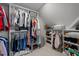 Organized walk-in closet with ample hanging space, shelving, and storage for clothing and shoes at 120 Harmony Hill Ln, Cary, NC 27513