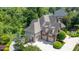 Luxury home with a large driveway, three-car garage, and lush landscaping under a sunny sky at 12317 Richmond Run Dr, Raleigh, NC 27614