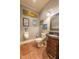 Unique powder room featuring a decorative urinal and antique-style vanity sink at 12317 Richmond Run Dr, Raleigh, NC 27614