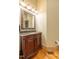 Bathroom features a decorative vanity with dark wood finish and decorative mirror at 12317 Richmond Run Dr, Raleigh, NC 27614