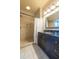 Bathroom showcasing a tiled shower with glass doors and a sleek vanity with modern fixtures at 12317 Richmond Run Dr, Raleigh, NC 27614