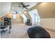 Spacious bonus room with neutral carpet, dormer windows, and ceiling fans provides versatile living space at 12317 Richmond Run Dr, Raleigh, NC 27614
