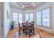 Bright breakfast nook with round table, surrounded by windows providing natural light and outdoor views at 12317 Richmond Run Dr, Raleigh, NC 27614