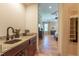 Butler pantry with sink, granite countertop, and view to main bedroom at 12317 Richmond Run Dr, Raleigh, NC 27614