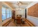 Dining room with a large window, hardwood floors, decorative ceiling, and a rustic chandelier at 12317 Richmond Run Dr, Raleigh, NC 27614