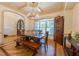 Elegant dining room with hardwood floors, coffered ceiling and large window at 12317 Richmond Run Dr, Raleigh, NC 27614