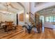 Open floor plan with hardwood floors with a dining room with decorative trim and stairs to second floor at 12317 Richmond Run Dr, Raleigh, NC 27614