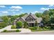 Beautiful two-story home with manicured landscaping, stone accents, and a large driveway leading to a 3-car garage at 12317 Richmond Run Dr, Raleigh, NC 27614