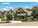 Two-story home featuring stone and siding with a well-manicured lawn and mature landscaping at 12317 Richmond Run Dr, Raleigh, NC 27614
