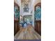 Elegant foyer with hardwood floors, stairs, a balcony, and a glimpse into the inviting living spaces at 12317 Richmond Run Dr, Raleigh, NC 27614