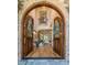Grand foyer with hardwood floors, arched doorways, a staircase, and a view into the living room at 12317 Richmond Run Dr, Raleigh, NC 27614