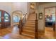 Spacious foyer with hardwood floors, staircase, and elegant entry doors providing a grand welcome at 12317 Richmond Run Dr, Raleigh, NC 27614